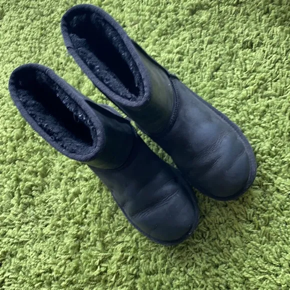 UGG black waterproof boots for a boy or a girl.
